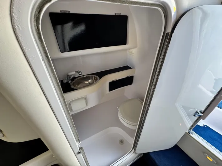  Yacht Photos Pics 2004 Donzi 38 ZX boat bathroom with sink, toilet, and shower.