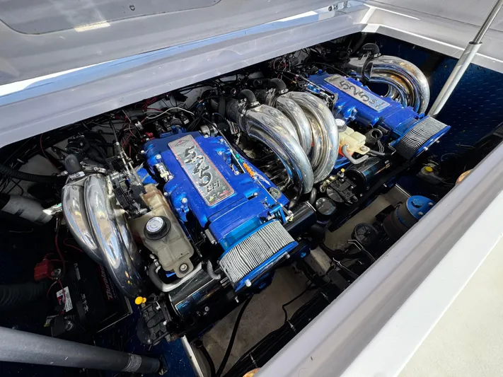  Yacht Photos Pics 2004 Donzi 38 ZX boat engine compartment with dual blue engines and chrome components.