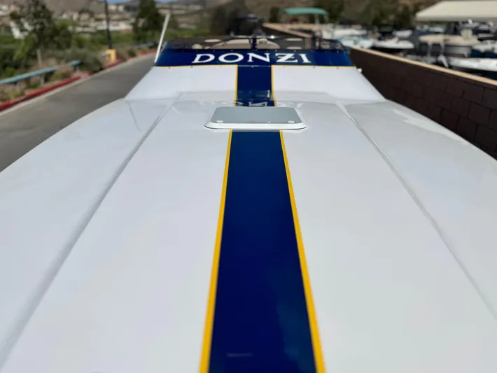  Yacht Photos Pics 2004 Donzi 38 ZX boat with blue and yellow stripe on deck.