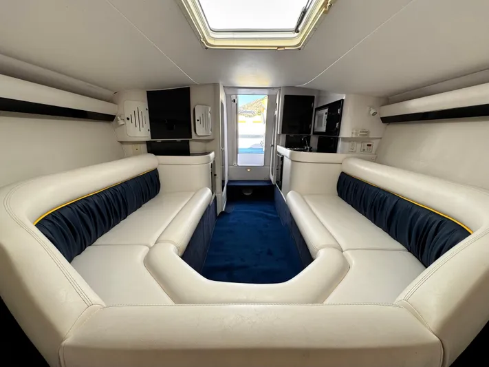  Yacht Photos Pics 2004 Donzi 38 ZX cabin interior with white and blue seating, skylight, and modern amenities.