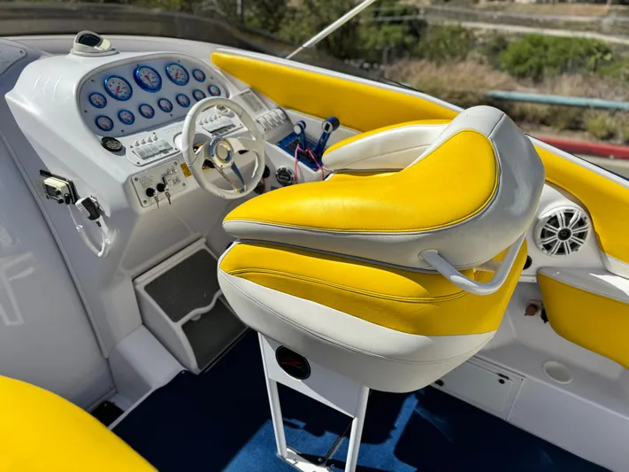  Yacht Photos Pics 2004 Donzi 38 ZX cockpit with yellow and white seating, detailed dashboard, and steering wheel.