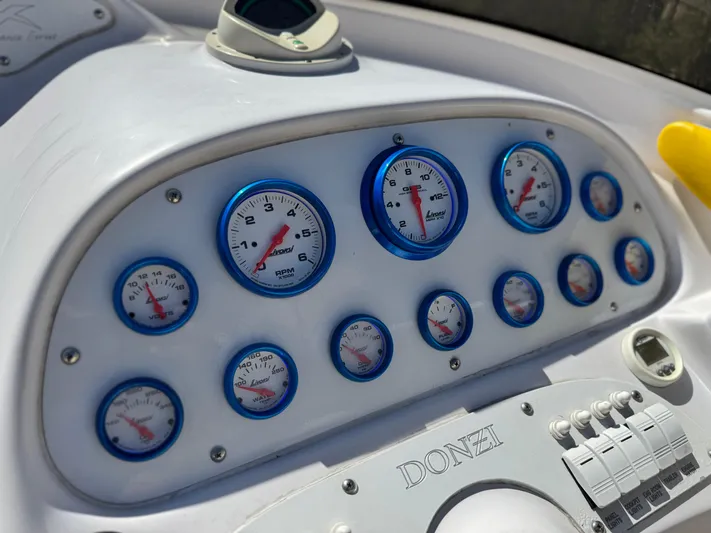  Yacht Photos Pics Dashboard of a 2004 Donzi 38 ZX boat with multiple gauges and controls.