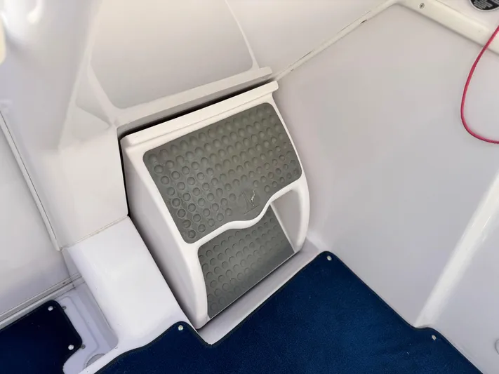  Yacht Photos Pics 2004 Donzi 38 ZX boat interior with footrest and blue carpet.