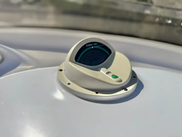  Yacht Photos Pics Close-up of a 2004 Donzi 38 ZX boat compass on a white dashboard.