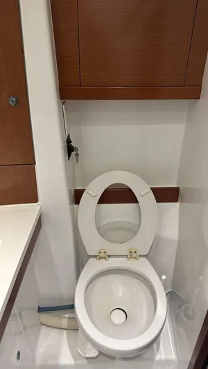  Yacht Photos Pics Beneteau Oceanis 50 yacht bathroom with toilet, wooden cabinets, and modern design, 2013 model.