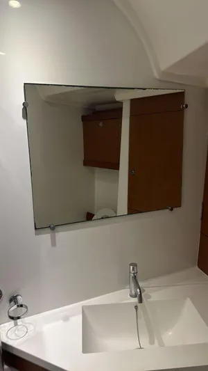  Yacht Photos Pics Bathroom interior of 2013 Beneteau Oceanis 50 yacht with mirror and sink.