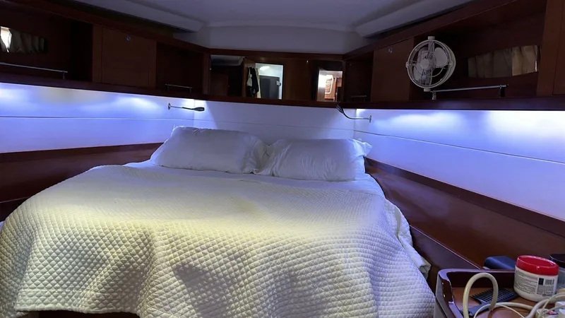  Yacht Photos Pics Cabin interior of 2013 Beneteau Oceanis 50 yacht with cozy bed and ambient lighting.
