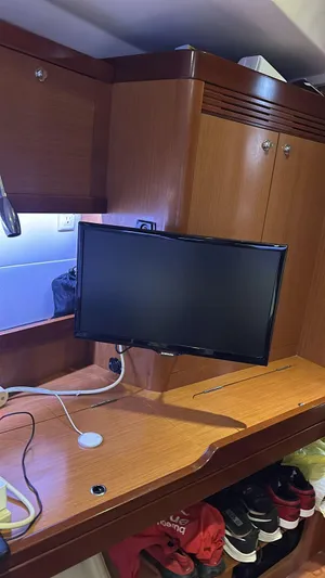  Yacht Photos Pics Interior of 2013 Beneteau Oceanis 50 yacht with desk and monitor setup.