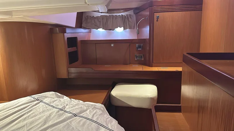  Yacht Photos Pics Cabin interior of 2013 Beneteau Oceanis 50 yacht with wooden furnishings and cozy bed.