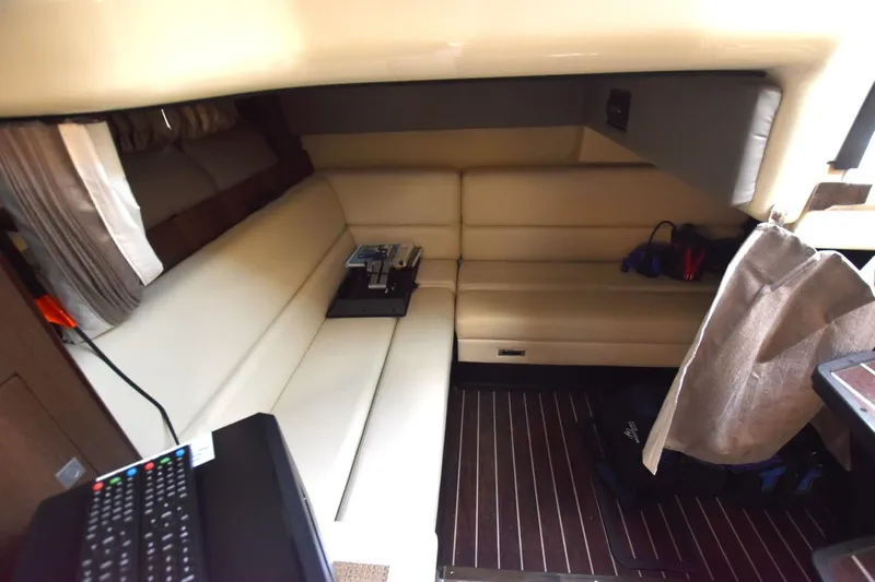 Dauntless Yacht Photos Pics Interior of 2017 Monterey 355 Sport Yacht with beige seating and wooden flooring.