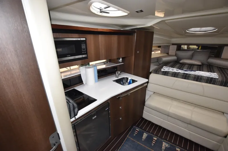 Dauntless Yacht Photos Pics 2017 Monterey 355 Sport Yacht interior with kitchenette and cozy seating area.