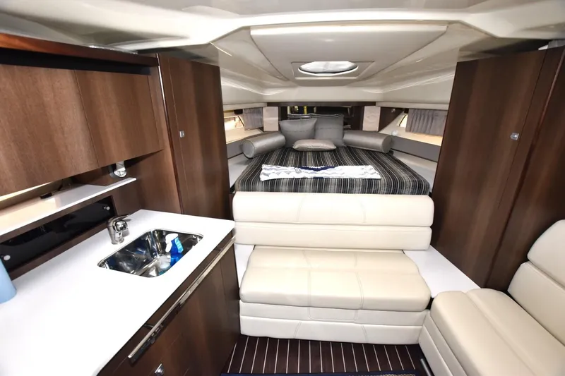 Dauntless Yacht Photos Pics Interior of 2017 Monterey 355 Sport Yacht with modern kitchen and cozy sleeping area.