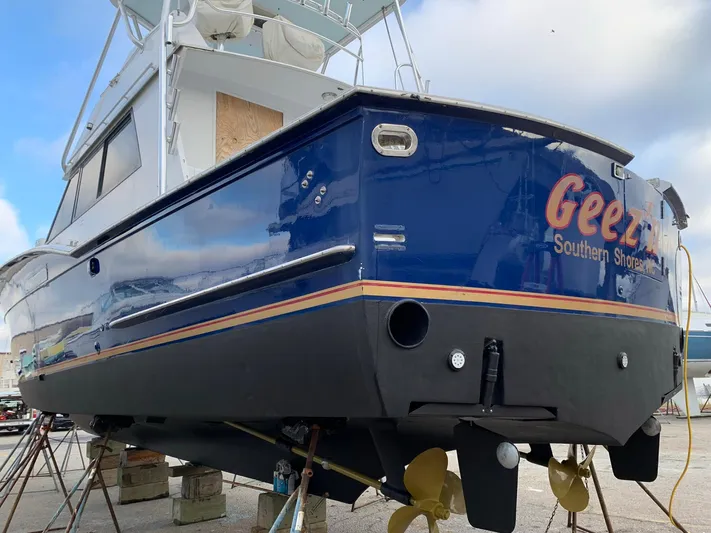 Yacht Photos Pics 1980 Hatteras 46 Convertible boat on stands, blue hull, visible propellers.
