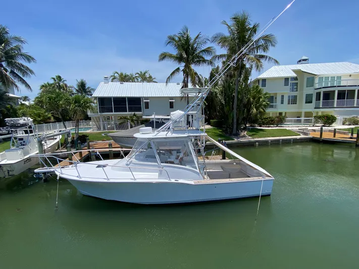  Yacht Photos Pics A 1995 L&H 33 boat docked in a tropical marina setting.