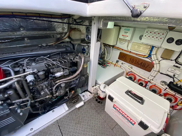  Yacht Photos Pics Engine room of a 1995 L&H 33 boat, featuring a Yanmar engine and control systems.