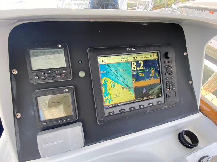  Yacht Photos Pics Control panel of a 1995 L&H 33 boat with navigation and radar displays.