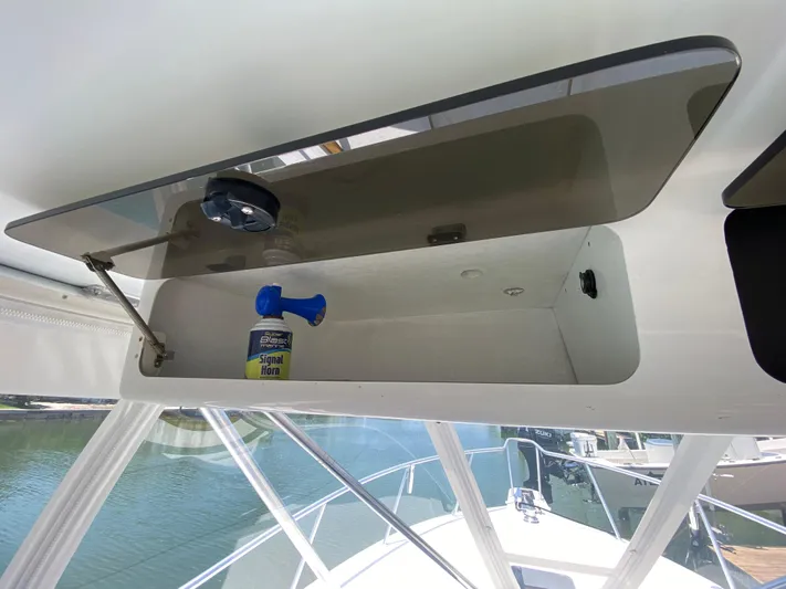  Yacht Photos Pics Open storage compartment on 1995 L&H 33 boat with signal horn inside.