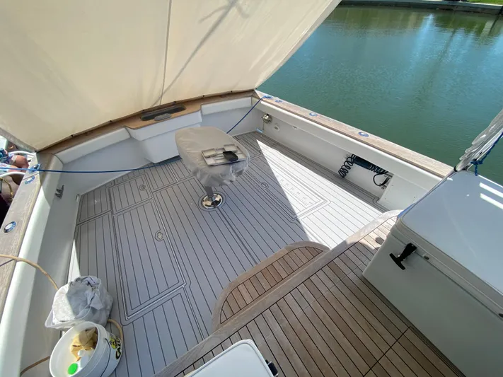  Yacht Photos Pics Open deck of 1995 L&H 33 boat with wooden flooring and seating.