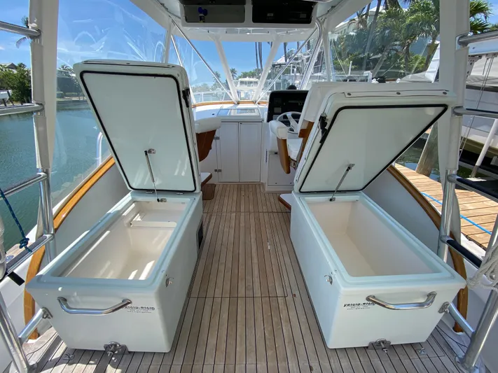  Yacht Photos Pics Open storage compartments on a 1995 L&H 33 boat with wooden deck.