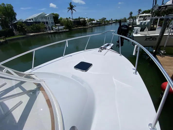  Yacht Photos Pics Bow view of 1995 L&H 33 boat docked in a scenic canal.