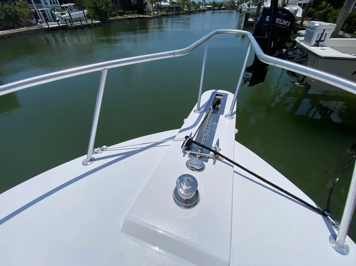  Yacht Photos Pics Bow view of 1995 L&H 33 boat on calm waterway.