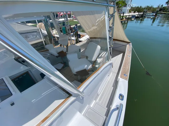  Yacht Photos Pics 1995 L&H 33 yacht with white seating, docked in a serene marina.