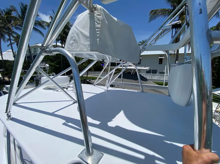  Yacht Photos Pics Rooftop view of a 1995 L&H 33 boat with metal railings and clear blue sky.