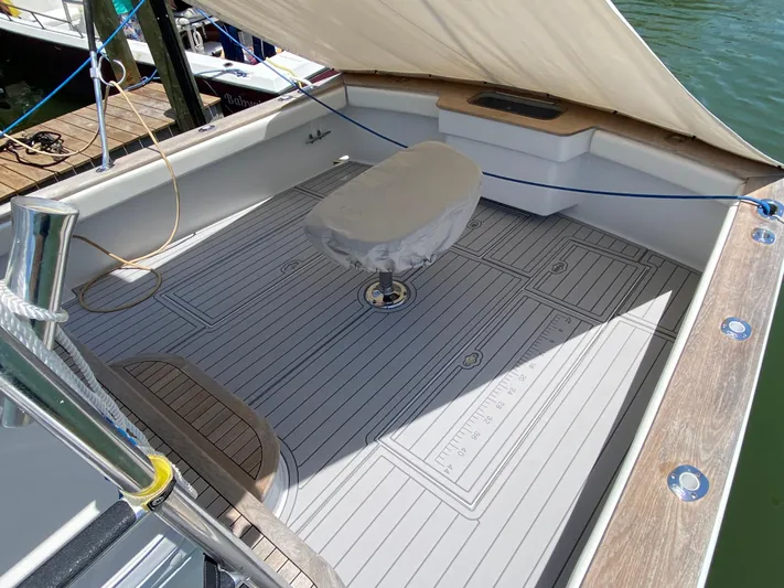  Yacht Photos Pics Spacious deck of a 1995 L&H 33 boat with covered seating and wooden flooring.