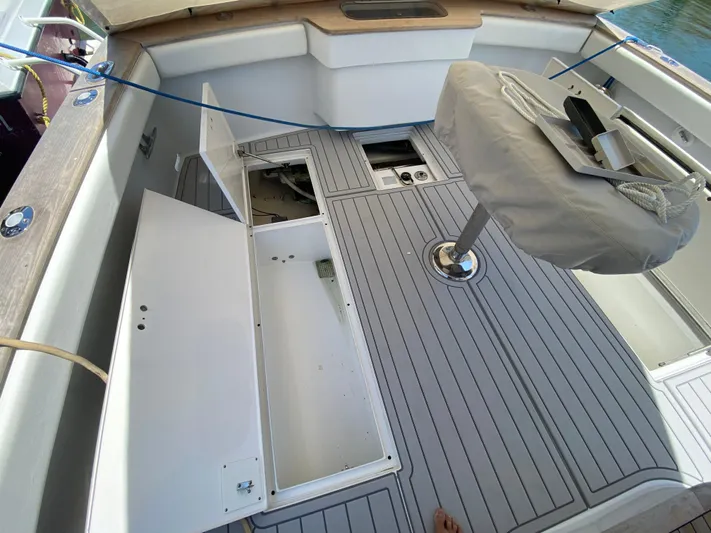  Yacht Photos Pics 1995 L&H 33 boat deck with open storage compartments and covered seat.