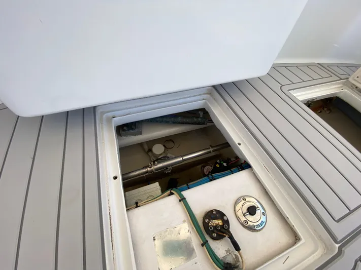  Yacht Photos Pics Open hatch on 1995 L&H 33 boat deck, revealing mechanical components.