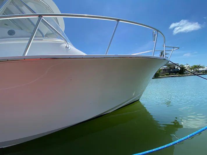  Yacht Photos Pics L&H 33 boat from 1995 docked on calm water under clear blue sky.