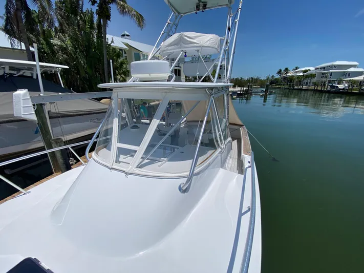  Yacht Photos Pics 1995 L&H 33 boat docked in a serene marina under clear blue skies.