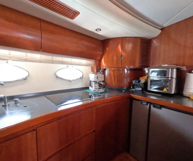 2004 Princess 65 @ Cancun Incentive Yacht Photos Pics Luxurious kitchen interior of a 2004 Princess 65 yacht with modern appliances.
