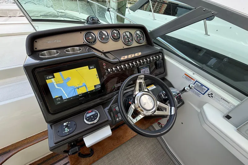  Yacht Photos Pics Cockpit of 2016 Sea Ray 350 Sundancer with navigation display and steering wheel.