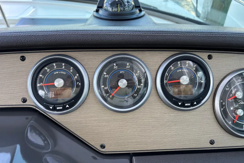  Yacht Photos Pics Dashboard of a 2016 Sea Ray 350 Sundancer boat with gauges and compass.