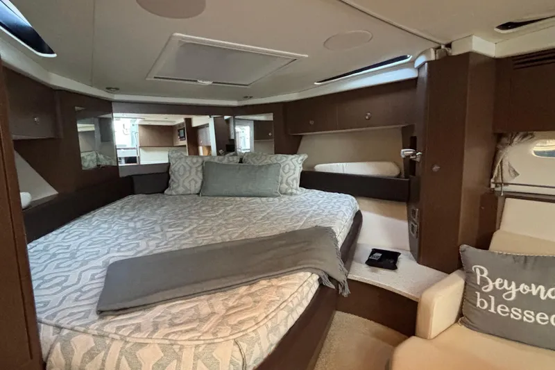  Yacht Photos Pics Luxurious interior of 2016 Sea Ray 350 Sundancer yacht with cozy bedding and elegant decor.
