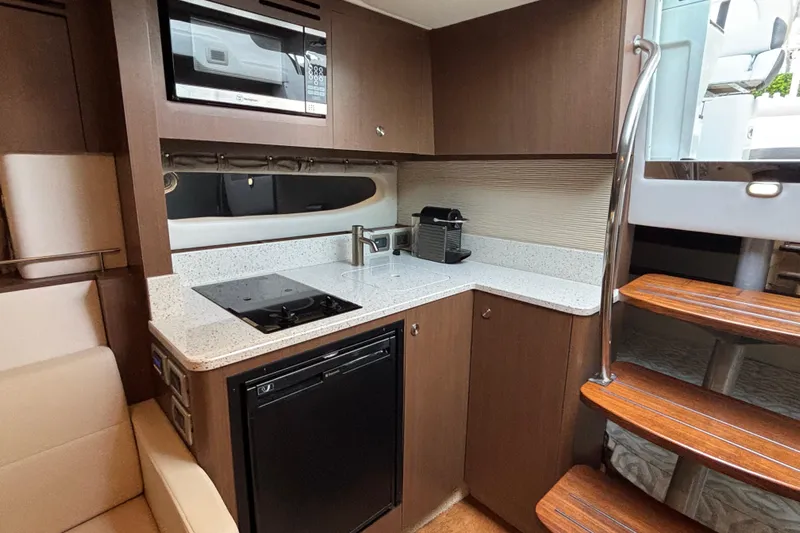  Yacht Photos Pics Modern kitchen in 2016 Sea Ray 350 Sundancer yacht with sleek appliances and wooden cabinetry.