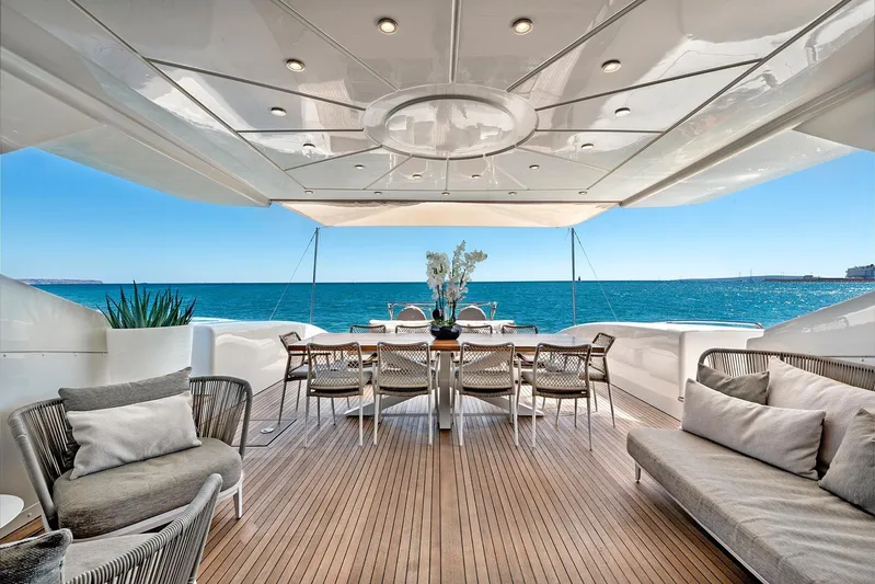  Yacht Photos Pics Luxurious 2004 Mangusta 130 yacht deck with elegant seating and ocean view.