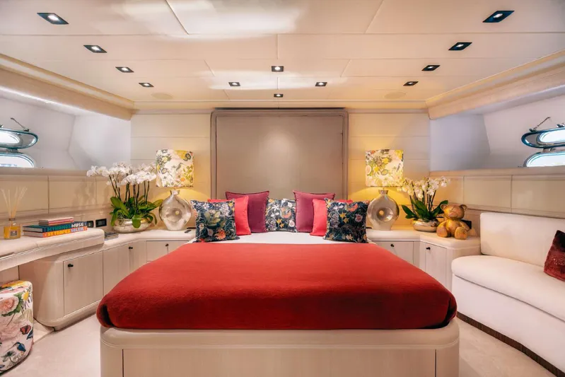  Yacht Photos Pics Luxurious 2004 Mangusta 130 yacht bedroom with elegant decor and vibrant red bedding.