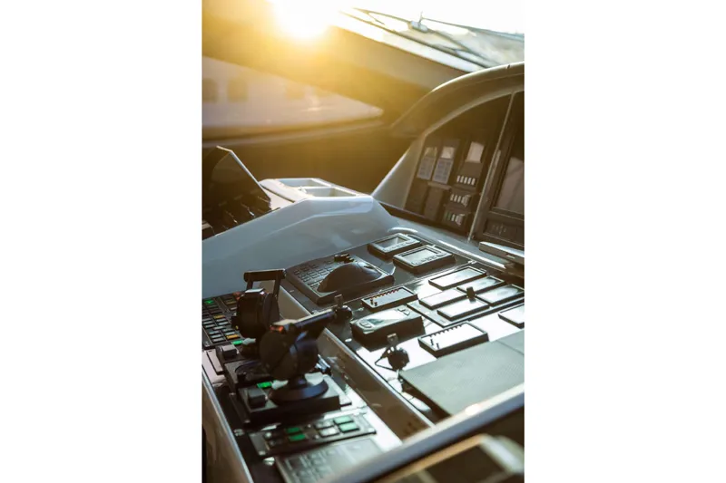  Yacht Photos Pics Cockpit of 2004 Mangusta 130 yacht with sunlight streaming through windows.