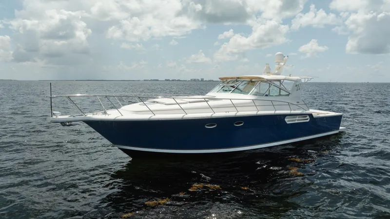  Yacht Photos Pics 1998 Tiara Yachts 4300 Open cruising on calm ocean waters under a cloudy sky.