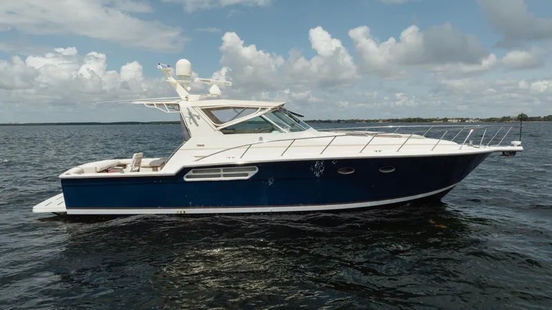  Yacht Photos Pics 1998 Tiara Yachts 4300 Open cruising on a calm sea under a cloudy sky.