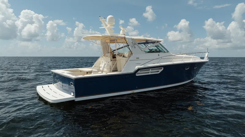  Yacht Photos Pics 1998 Tiara Yachts 4300 Open on calm ocean waters under a cloudy sky.