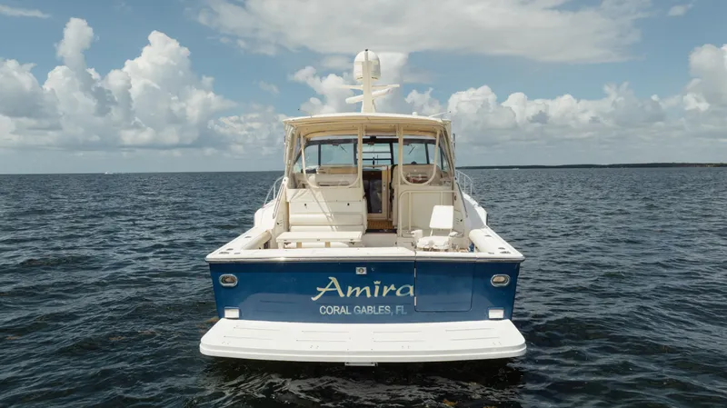  Yacht Photos Pics 1998 Tiara Yachts 4300 Open on water, rear view, blue hull, cloudy sky.