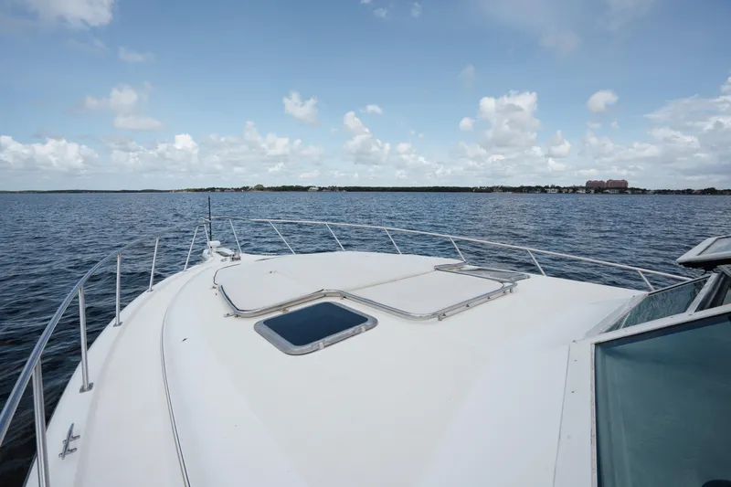  Yacht Photos Pics 1998 Tiara Yachts 4300 Open on calm water under a partly cloudy sky.