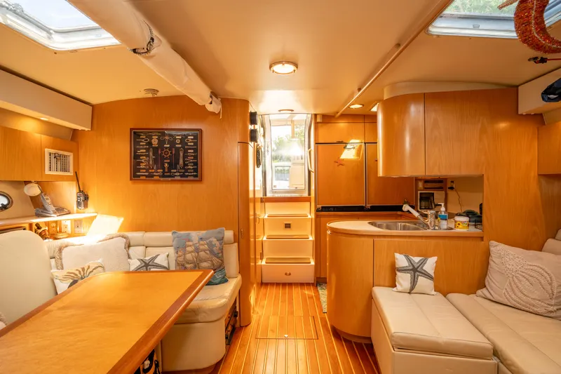  Yacht Photos Pics Interior of 1998 Tiara Yachts 4300 Open, featuring cozy seating and wooden cabinetry.