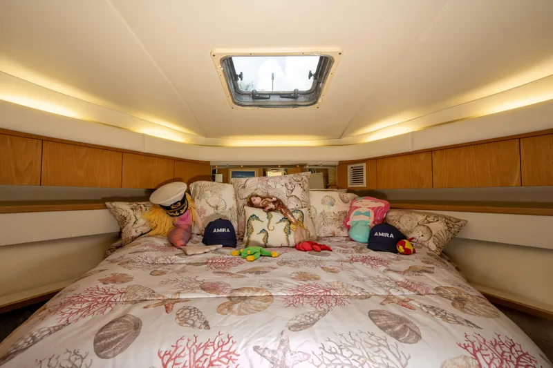  Yacht Photos Pics Cozy cabin interior of 1998 Tiara Yachts 4300 Open with nautical decor and bedding.