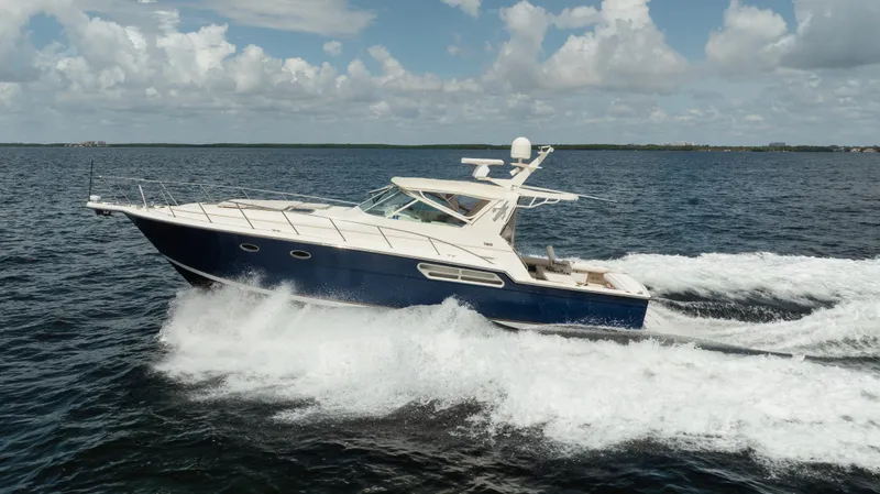  Yacht Photos Pics 1998 Tiara Yachts 4300 Open cruising on open water under a cloudy sky.