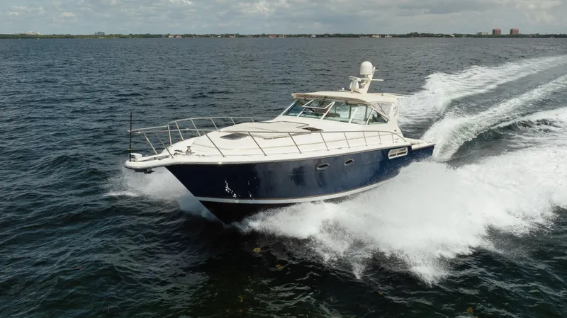  Yacht Photos Pics 1998 Tiara Yachts 4300 Open cruising on open water, creating a dynamic wake.