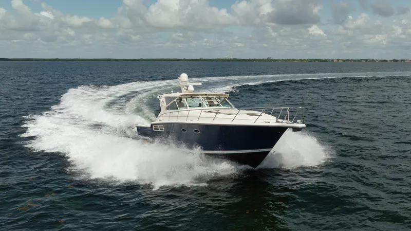  Yacht Photos Pics 1998 Tiara Yachts 4300 Open cruising on open water under a cloudy sky.